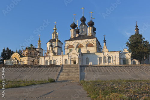 Street Embankment and Cathedral Dvorishche Veliky Ustyug in the rays of the setting sun, Vologda region, Russia photo