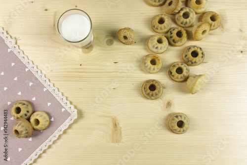 Small donuts on wood background - top view