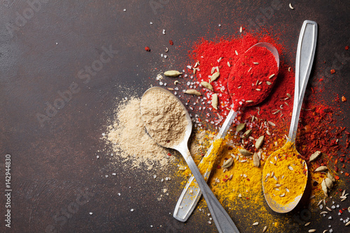 Fototapeta Naklejka Na Ścianę i Meble -  Various spices spoons on stone table