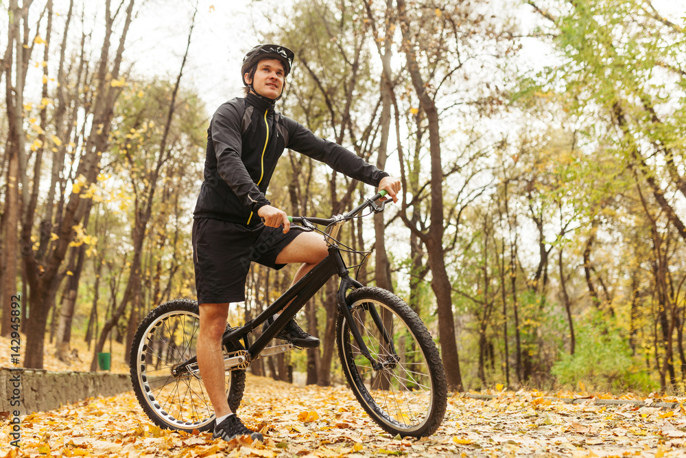 Fototapeta premium Man on bicycle in park