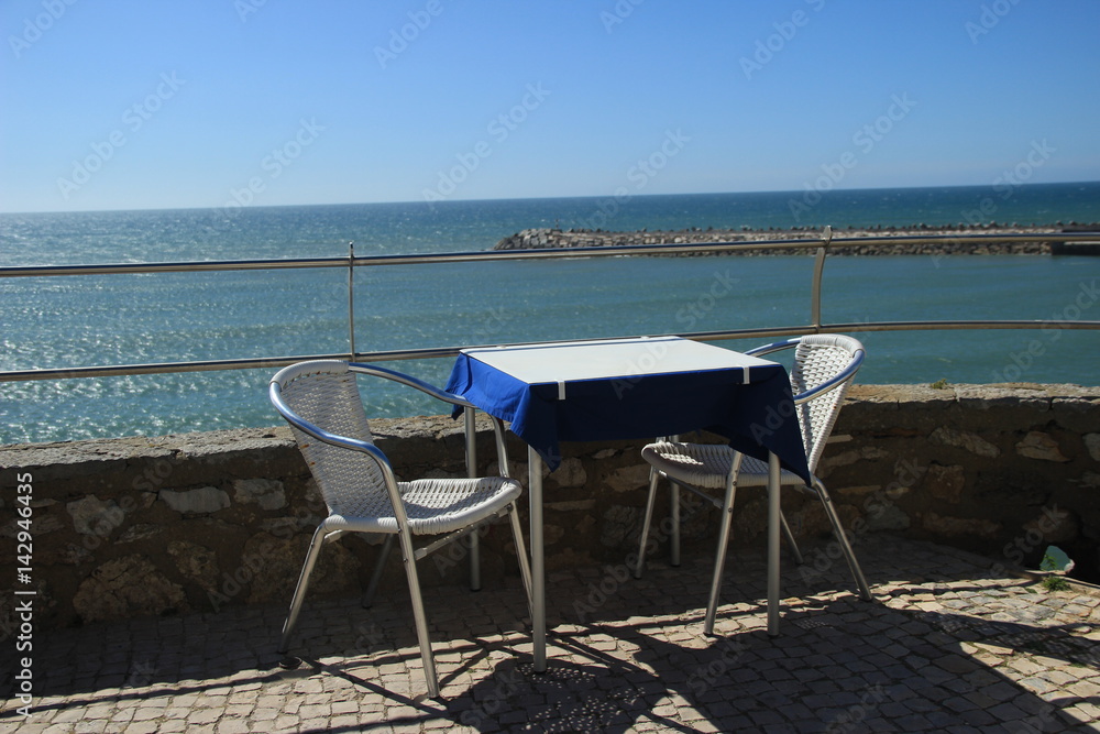 Table for two in a restaurant overlooking the sea