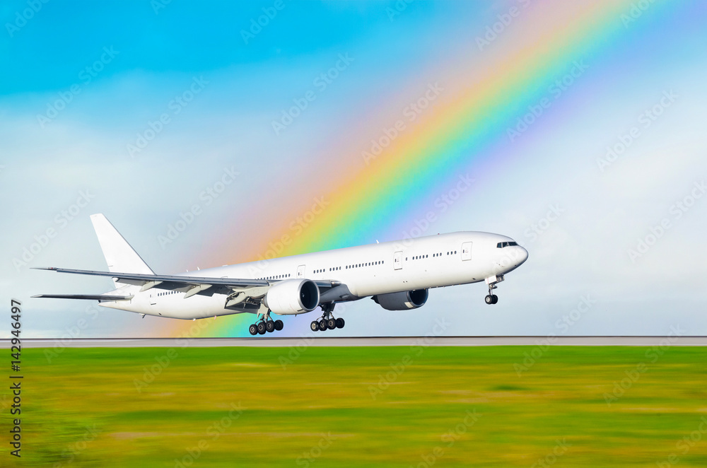 The airplane on the background of the rainbow landed at the airport The airplane on the background of the rainbow landed at the airport