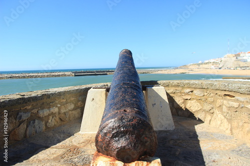 Old cannon next to a bay in ericeira Portugal