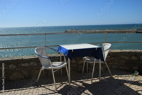 Table for two in a restaurant overlooking the sea © nvphoto