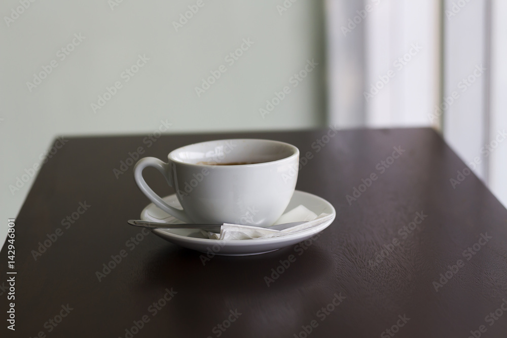 Fresh coffee in white cup on wooden table Fresh coffee in white cup on wooden table