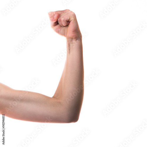 Tennage girl flexing biceps isolated on white