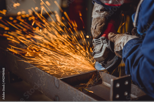 Worker Using Angle Grinder