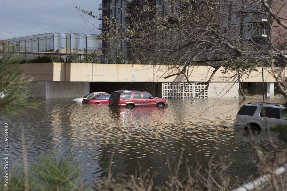 NEW YORK - November 1: Flooding in the parking lot in Far Rockaway after hurricane Sandy October 29, 2012 in New York City, NY NEW YORK - November 1: Flooding in the parking lot in Far Rockaway after hurricane Sandy October 29, 2012 in New York City, NY