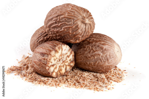 four nutmeg and powder isolated on white background