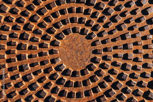 Concentric pattern on corroded manhole cover