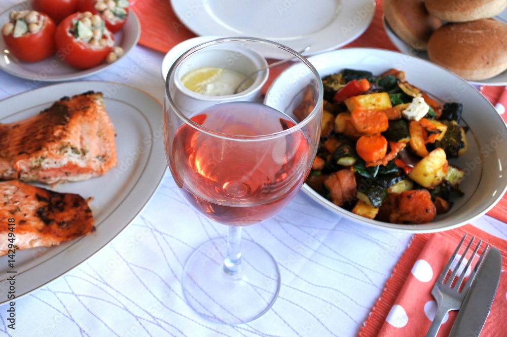 Glass of rose wine served with vegetarian food Glass of rose wine served with vegetarian food