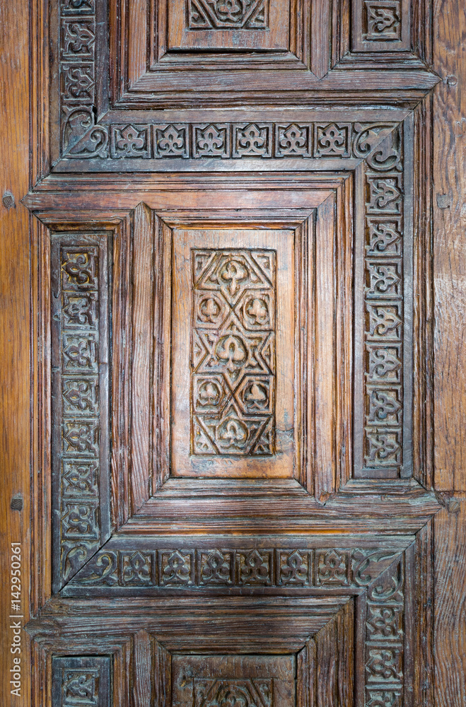 Ornaments of the wooden aged antique door at Madrasa and Mausoleum of As-Saleh Nagm Ad-Din Ayyub, Old Cairo, Egypt Ornaments of the wooden aged antique door at Madrasa and Mausoleum of As-Saleh Nagm Ad-Din Ayyub, Old Cairo, Egypt