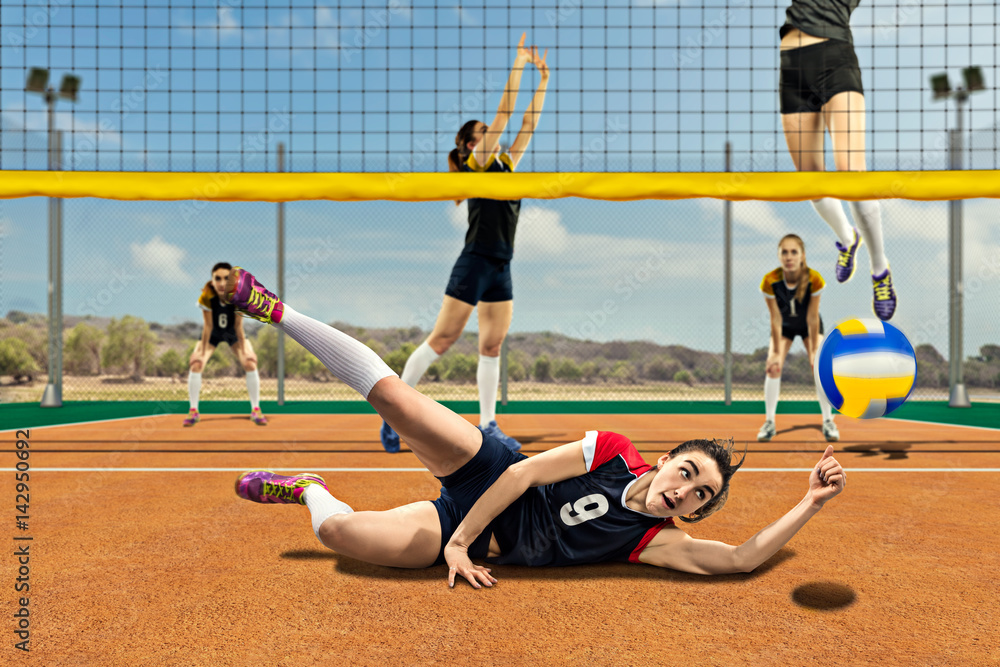Female volleyball player reaching the ball on the ground
