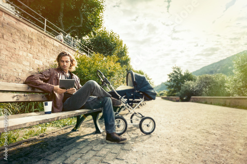 Young Father With Baby Stroller In The Park © nullplus