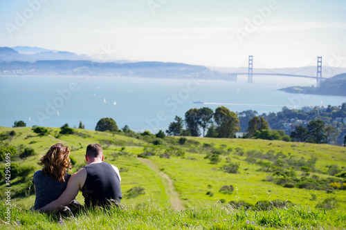 Couple Overlooks Golden Gate Bridge Sunny Day