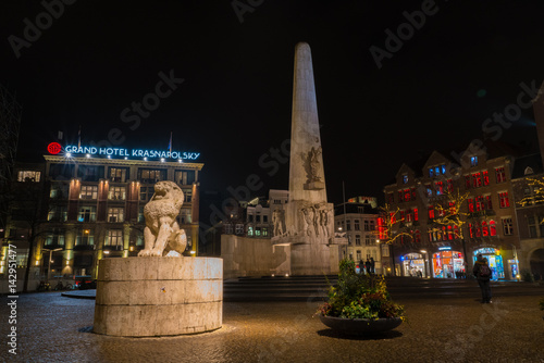 Some tourists watching the Monument on the Dam square at Night, Amsterdam, The Netherlands