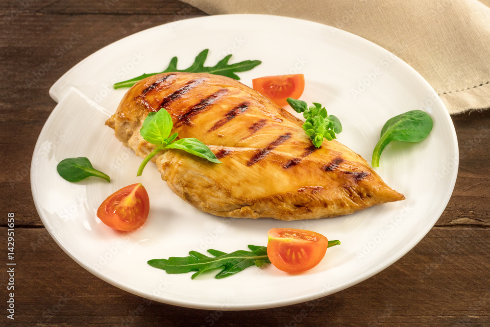 Grilled chicken fillet with cherry tomatoes and salad leaves