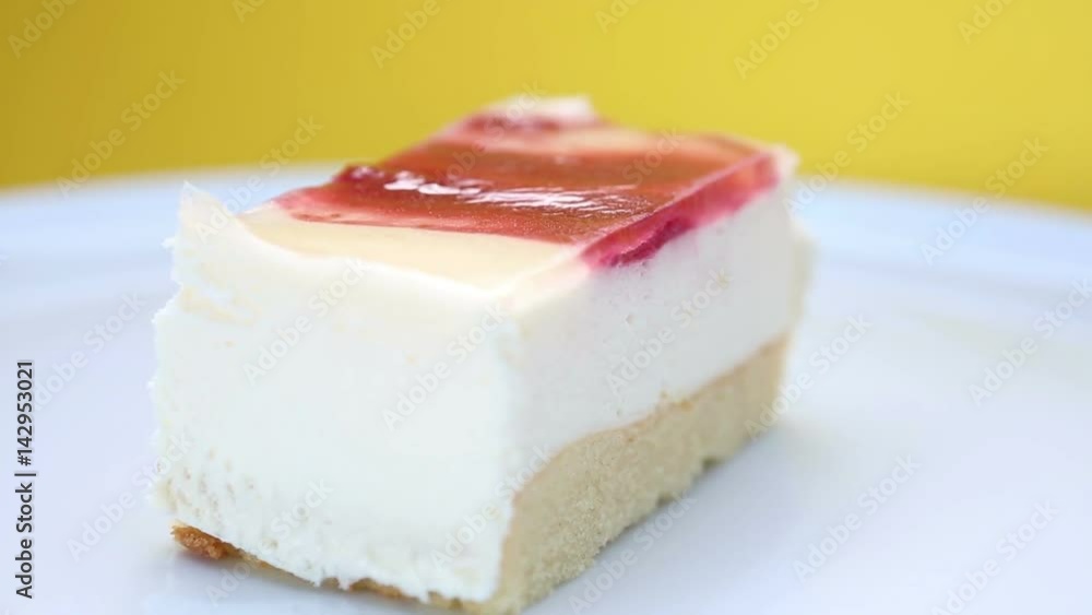 rotating plate with piece of square cream cake on yellow background
rotating plate with piece of square cream cake on yellow background