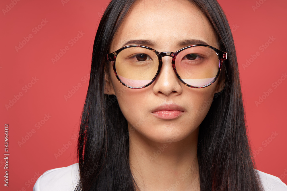 woman in glasses, asian appearance, red background woman in glasses, asian appearance, red background