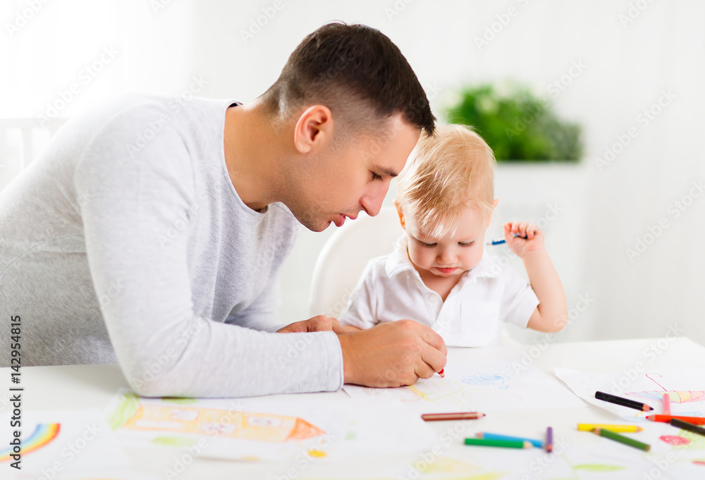 father and baby son paint together father and baby son paint together