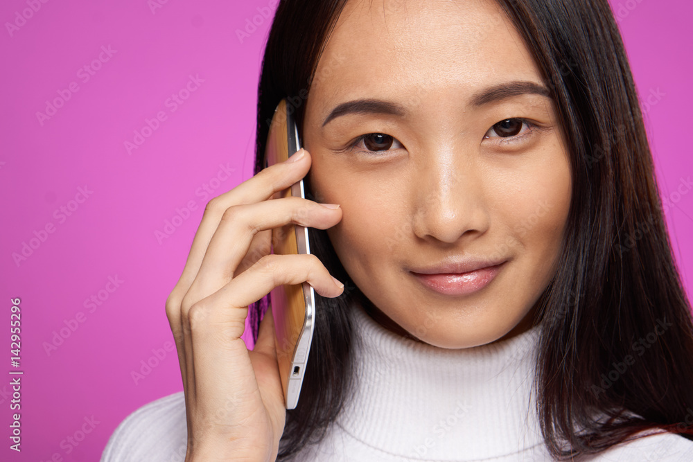 pink background and woman with phone in hand pink background and woman with phone in hand