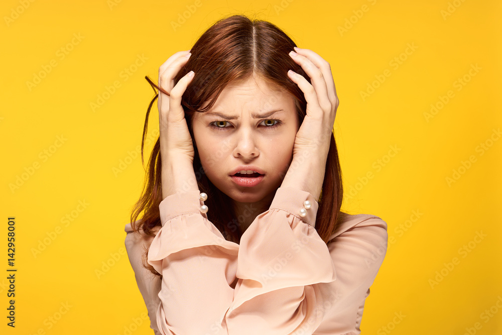 puzzled woman suing with her hands behind her head puzzled woman suing with her hands behind her head
