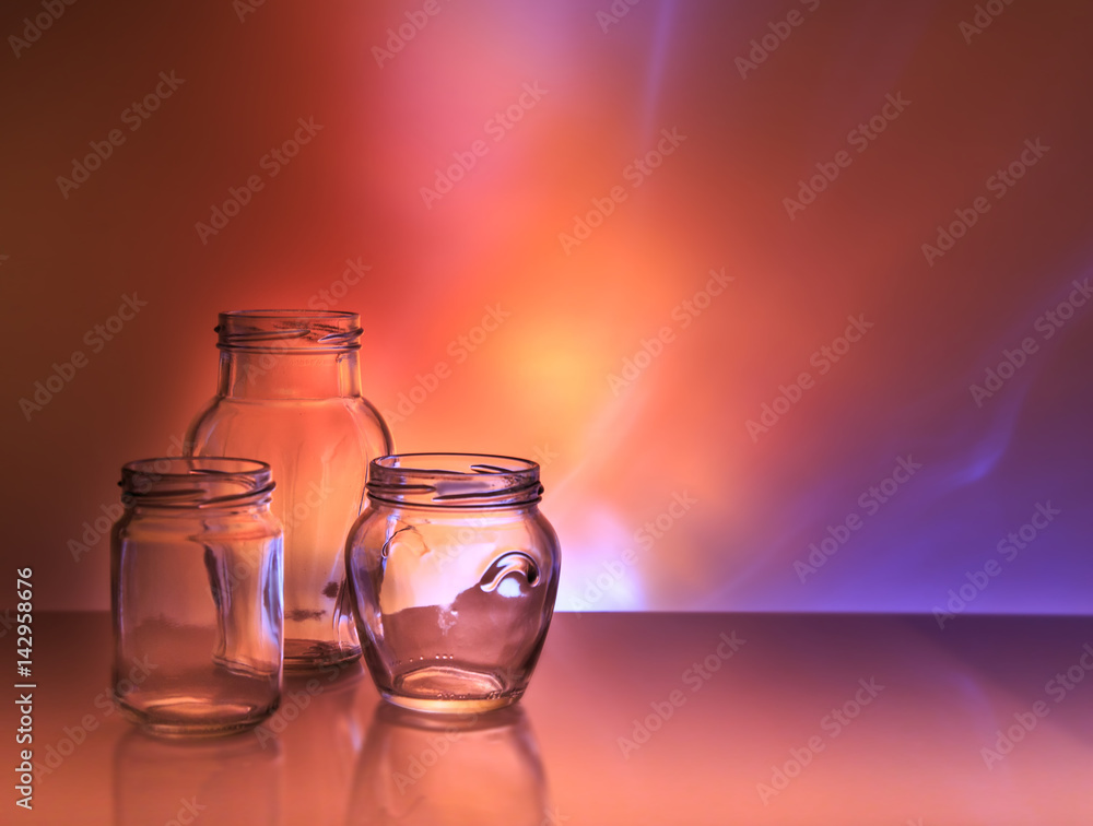 Three glass jars on a colored background Three glass jars on a colored background