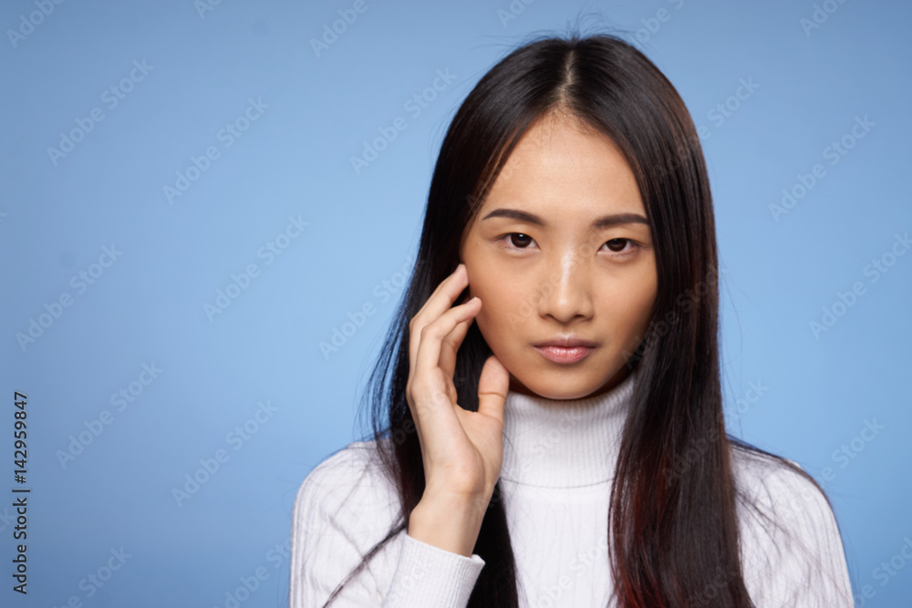 beautiful woman with dark hair on a blue background