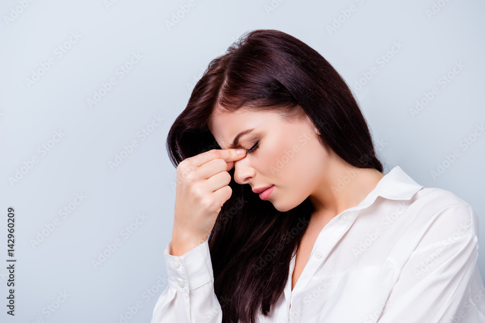 Side view portrait of sick young worker having a headache Side view portrait of sick young worker having a headache