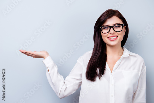 Successful confident young woman presenting new product