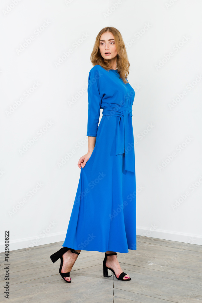 Young elegant female in light summer dress, over white background Young elegant female in light summer dress, over white background