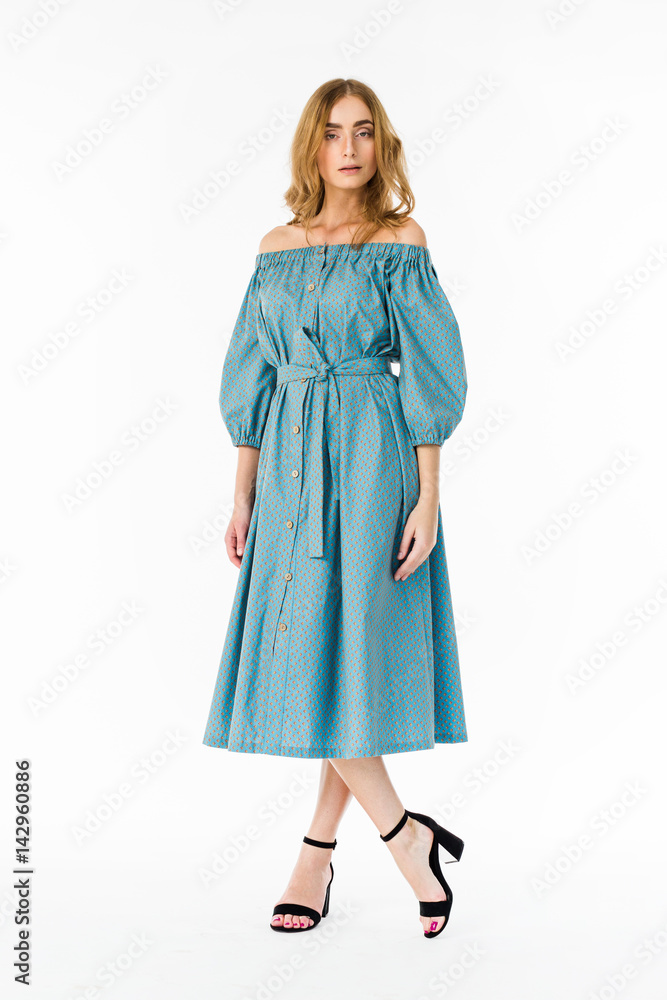 Fototapeta premium Young elegant female in light summer dress, over white background