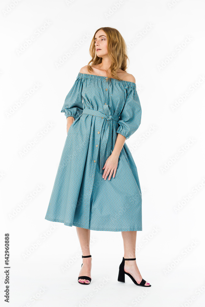 Fototapeta premium Young elegant female in light summer dress, over white background