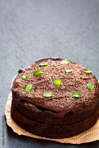 Belgian chocolate fudge cake on black stone background