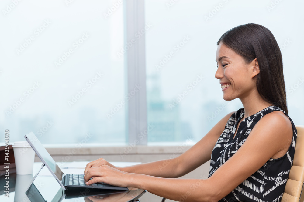 Asian business woman using laptop at work or home office Asian business woman using laptop at work or home office