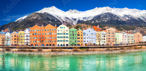 City scape in Innsbruck city center with beautiful houses, river Inn and Tyrolian Alps, Austria, Europe.
