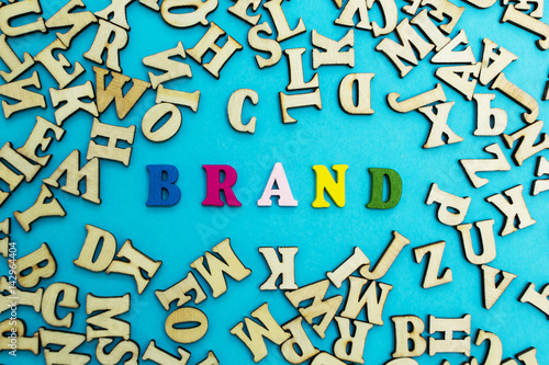 The word "brand" is lined with multicolored letters on a blue background.