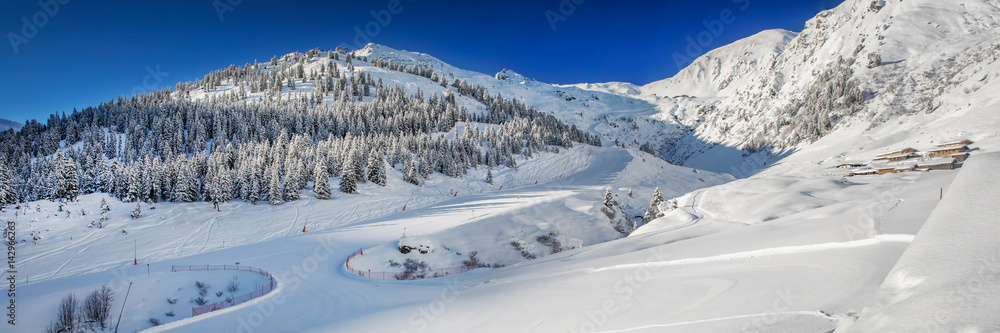 Trees and skiing slopes covered by fresh new snow in Tyrolian skiing resort  Zillertal arena, Austria.