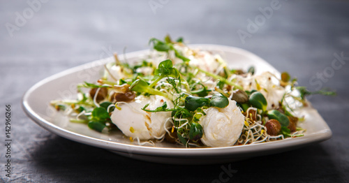 Raw Sprouts Microgreens.Fresh Green Salad with mozzarella,cheese.Concept of Healthy Food.Copy space for Text. selective focus.