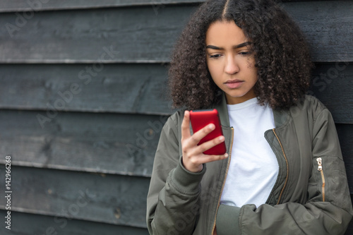 Foto Mixed Race African American Girl Teenager on Cell Phone