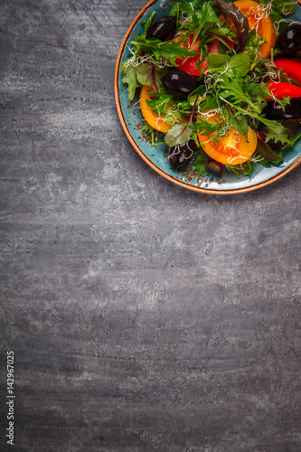 Fresh Green mix Salad with Vegetables, Tomatoes and Microgreen.Leaves Of Spinach,Arugula,Romaine,Lettuce.Concept of Healthy Food.Vegetarian.Copy space for Text. selective focus. photo