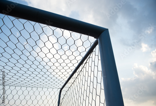 soccer goal against cloudy sky background.. © xy