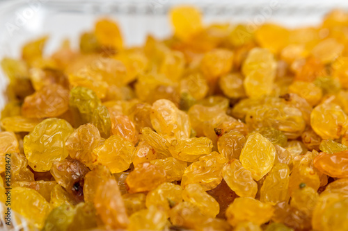 Dried golden raisins close up photo