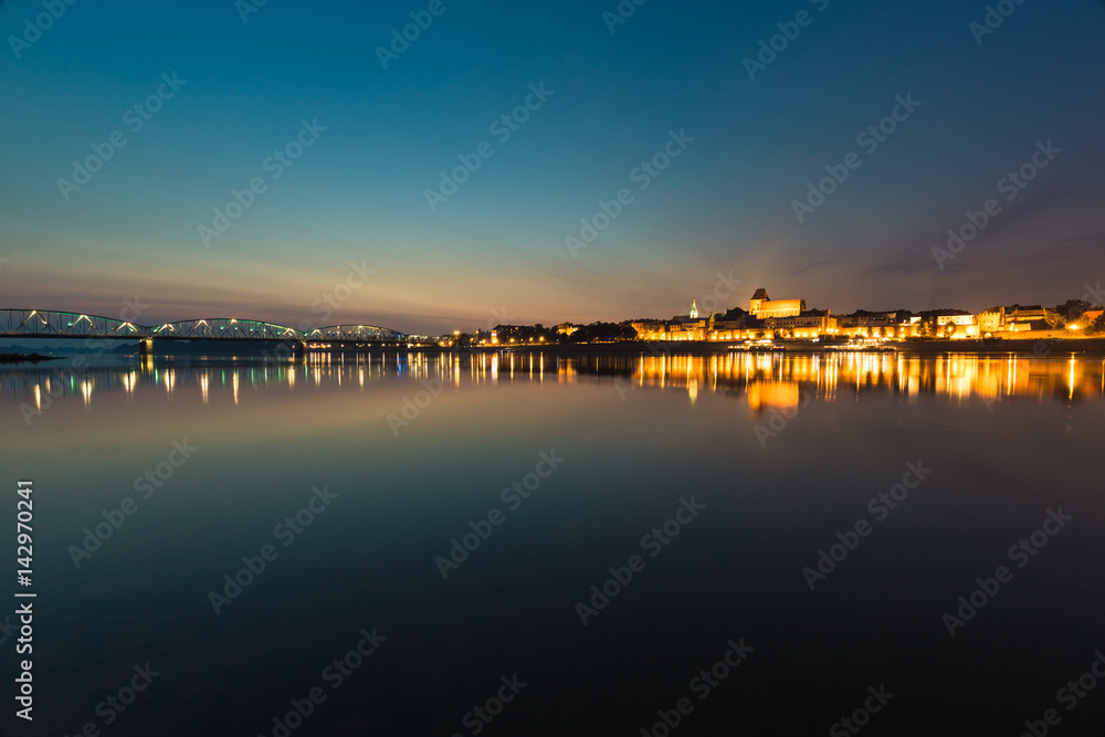 City of Torun in Poland, old town skyline by night from Vistula river