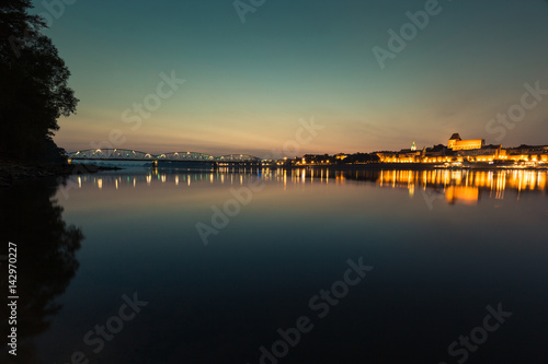 City of Torun in Poland  old town skyline by night from Vistula river
