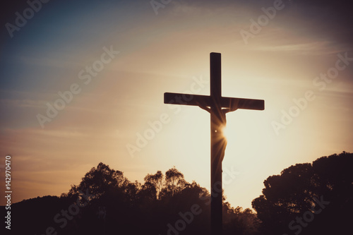 Fotografering Jesus Christ on the cross silhouette at sunset - crucifixion on the Calvary Hill