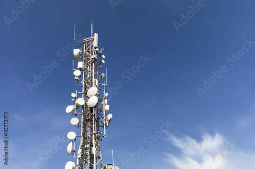 Telecommunication mast with radio cells for mobile phone net against deep blue sky