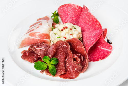 Dish of various types of meat-cutting on plate.