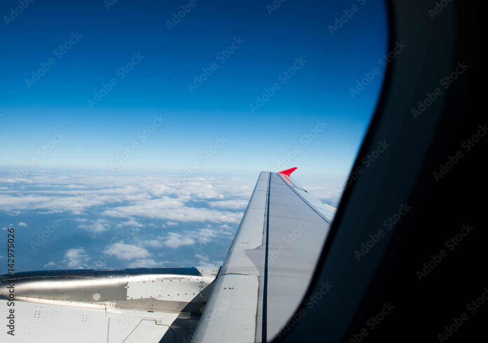Airplane at fly on the sky, view through aircraft window.