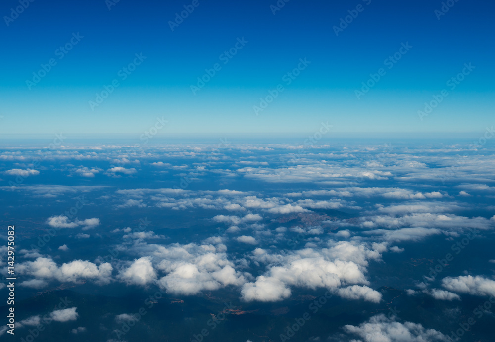 Blue sky with white clouds, view from a flying airplane. Blue sky with white clouds, view from a flying airplane.